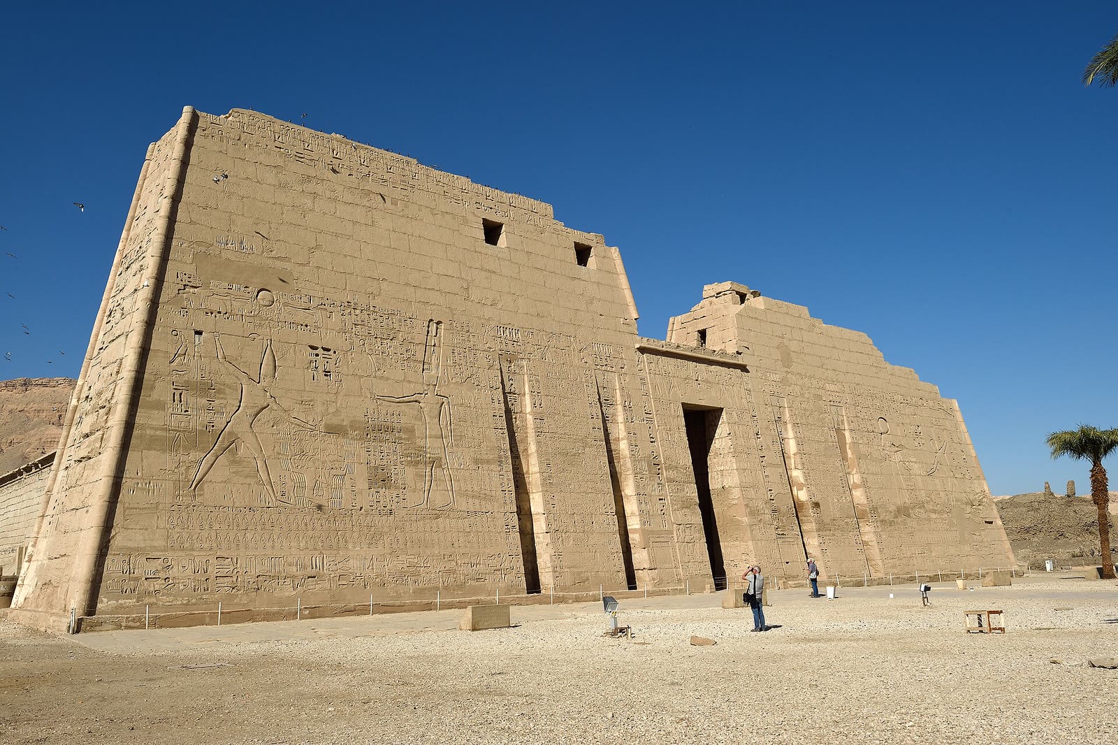 Medinet Habu temple pylon in Luxor under bright midday sun on the west bank